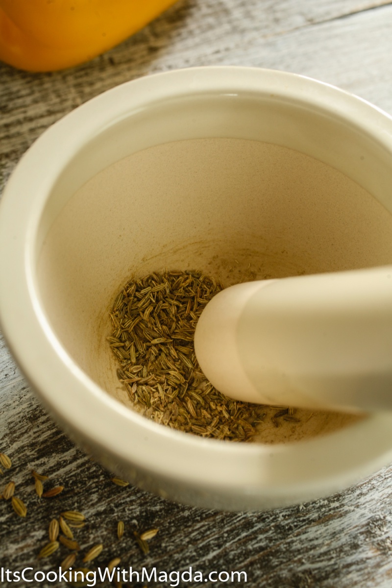 Fennel seeds crushed in a white mortar
