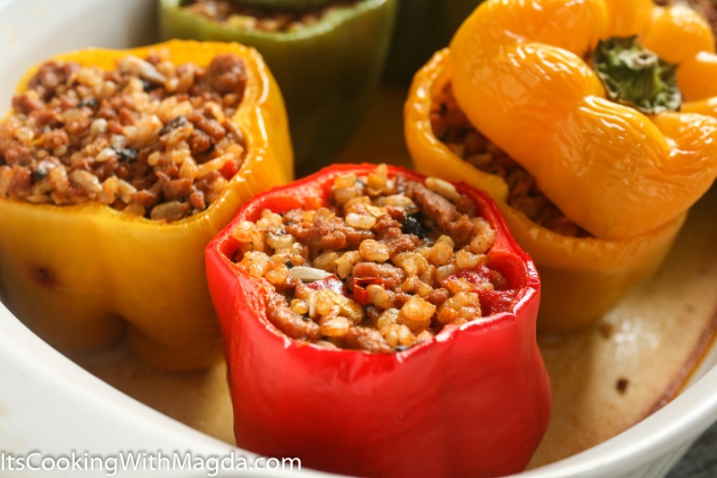 cooked bell peppers stuffed withrice, vegetables and ground turkey