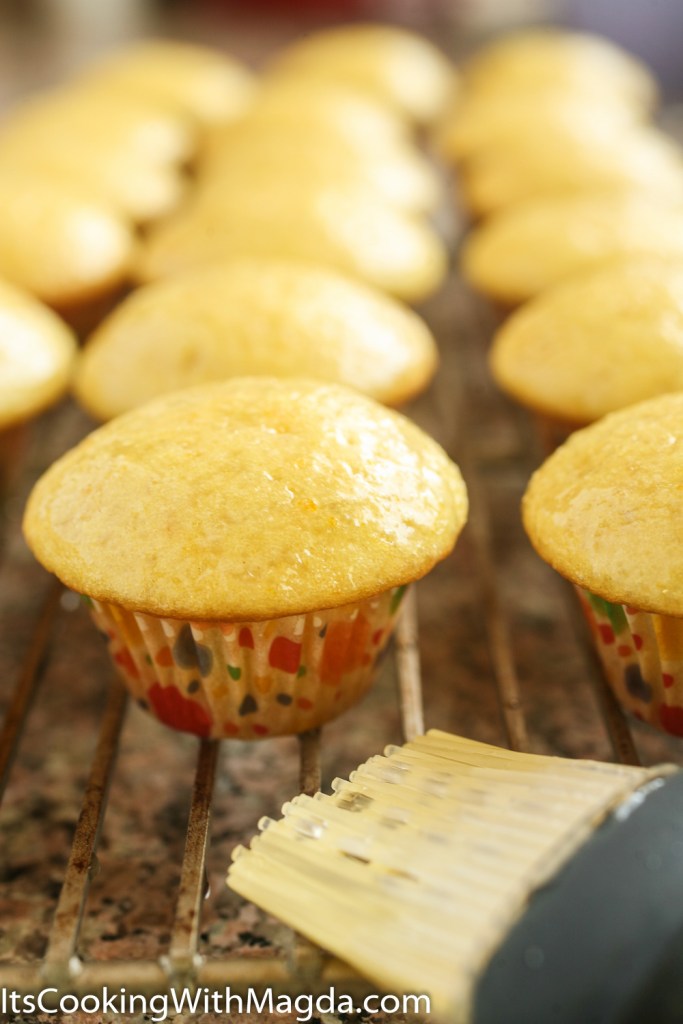 baked cupcakes glazed with lemon syrup