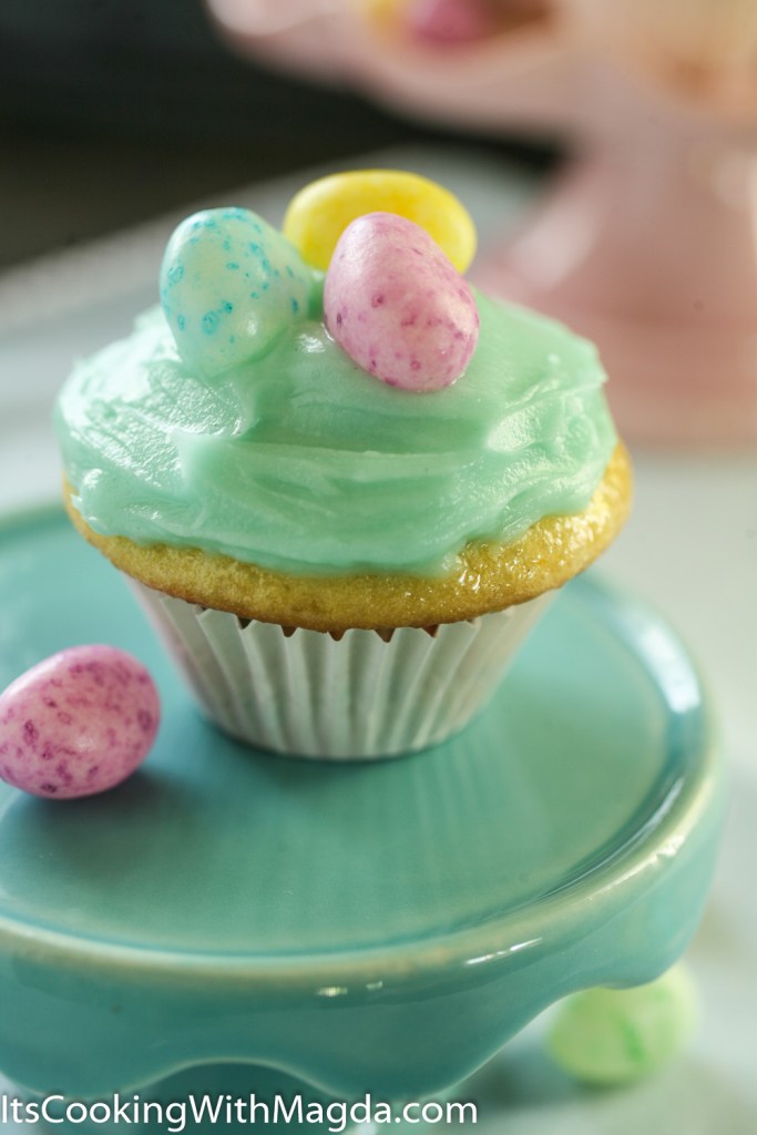 lemon cupcake with blue icing and jelly beans