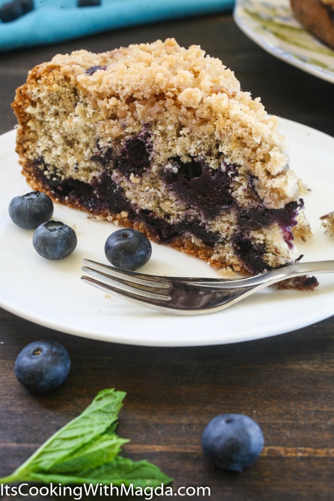 a slice of blueberry pie with crumb topping