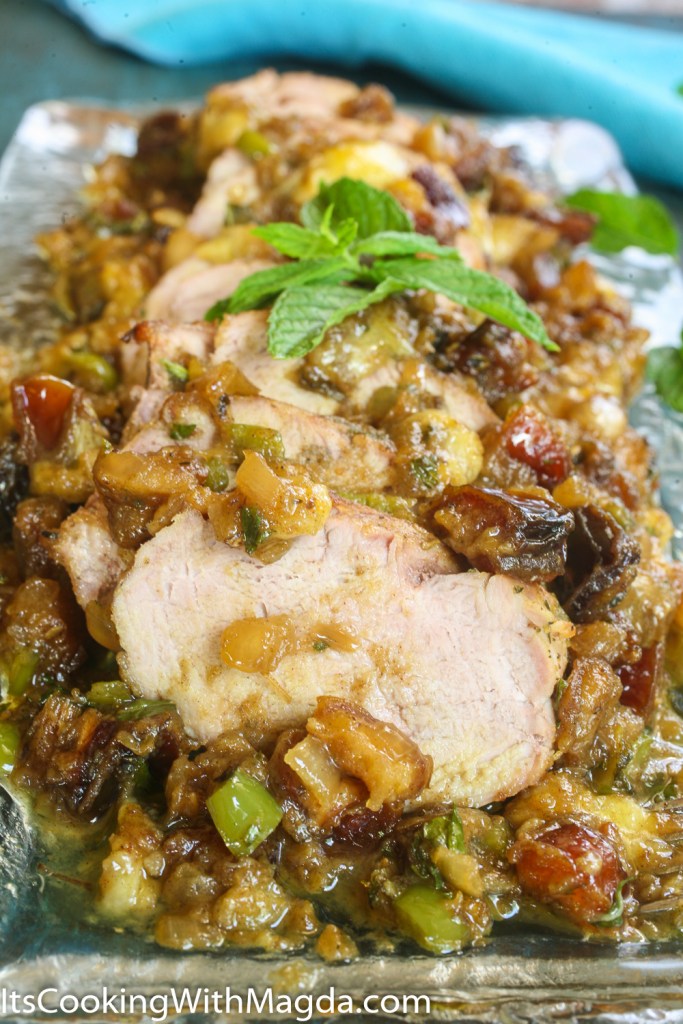 sliced pork tenderloin with banana and dates chutney on a plater