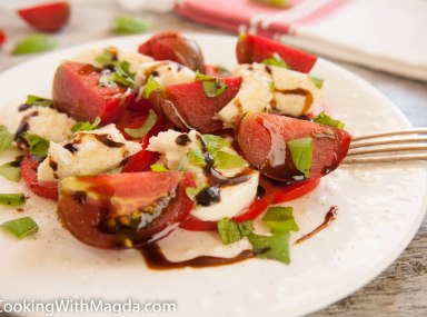 chunks of tomatoes, mozzarella cheese and chopped basil drizzled with balsamic vinegar