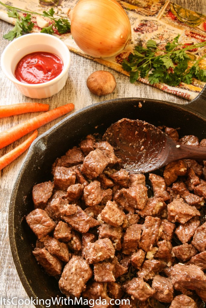 browned beef cubes with garlic on a skillet