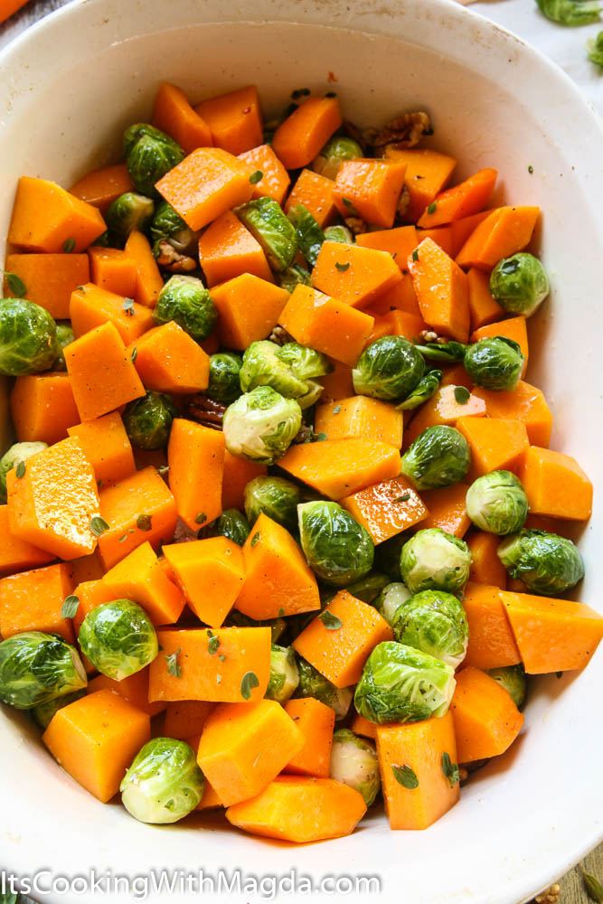 cubed butternut squash and Brussels sprouts in a baking dish