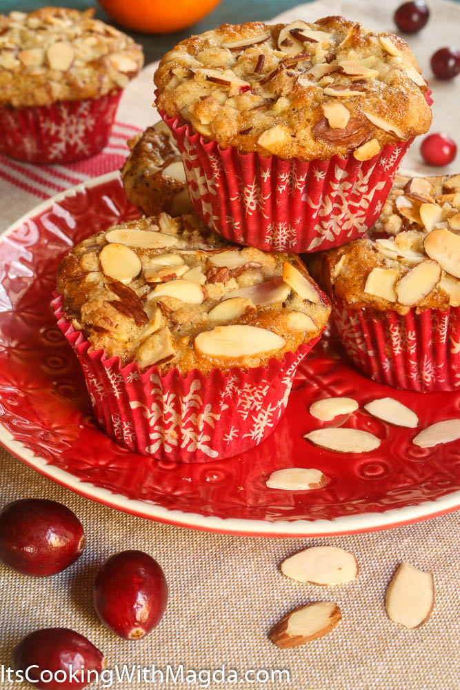 Cranberry Orange Muffins on a red plate with almond flakes