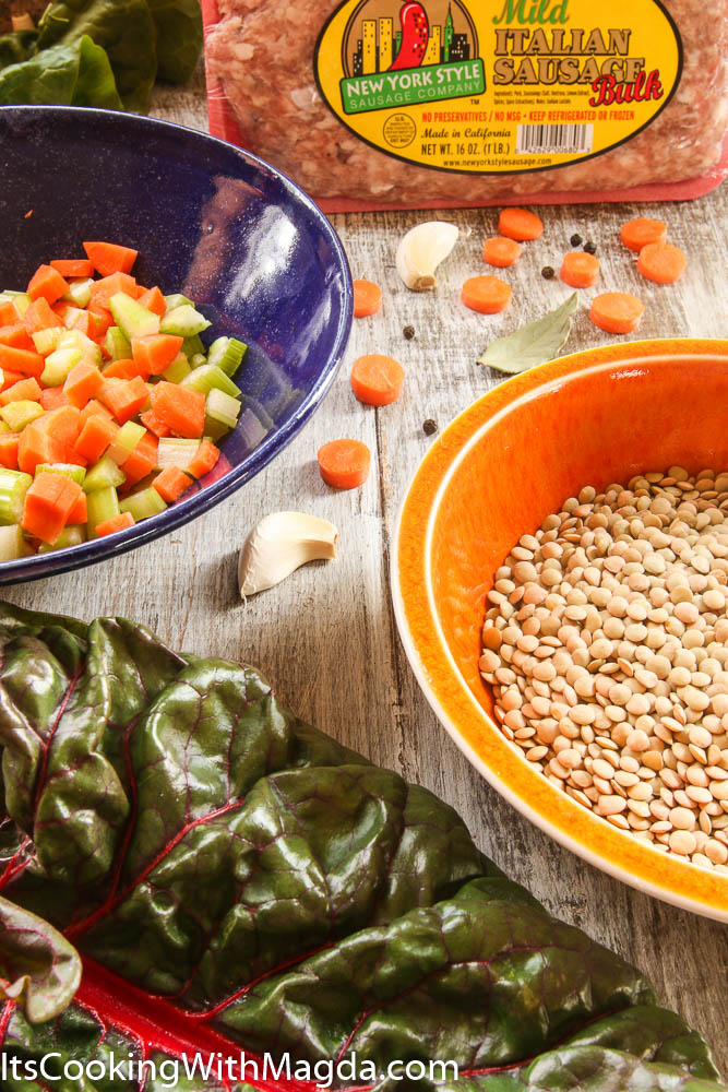 ingredients for soup: chard, lentils, garlic, carrots, sausage