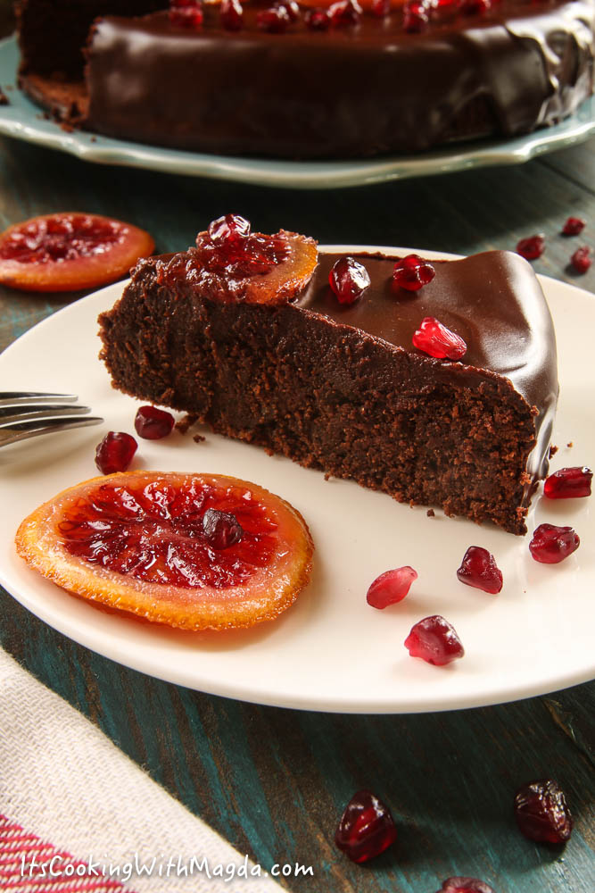 A slice of Buckwheat Chocolate orange cake with pomegranate seeds
