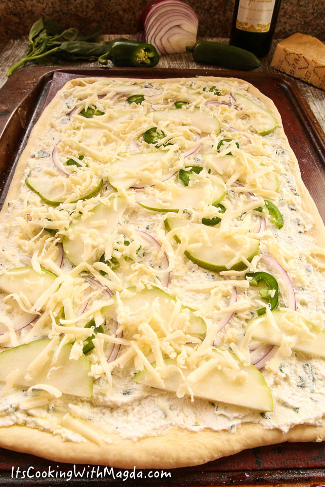 pizza with cheese, pear, onion and jalapeno before baking