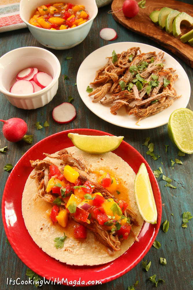 pork taco with mango salsa on a red plate