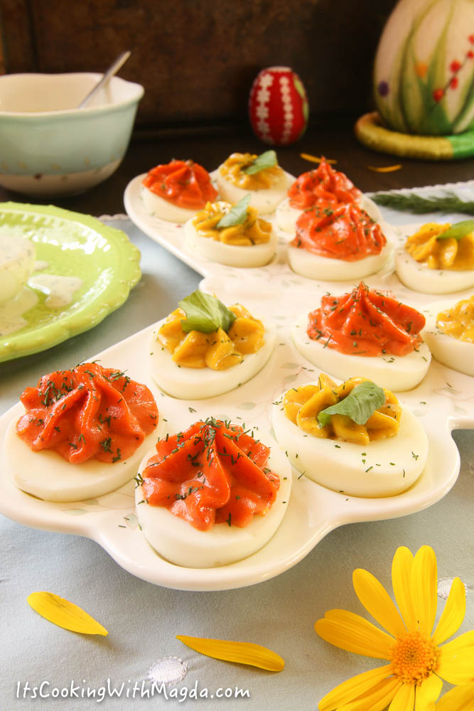 deviled eggs with tomato paste and curry on a lenox platter