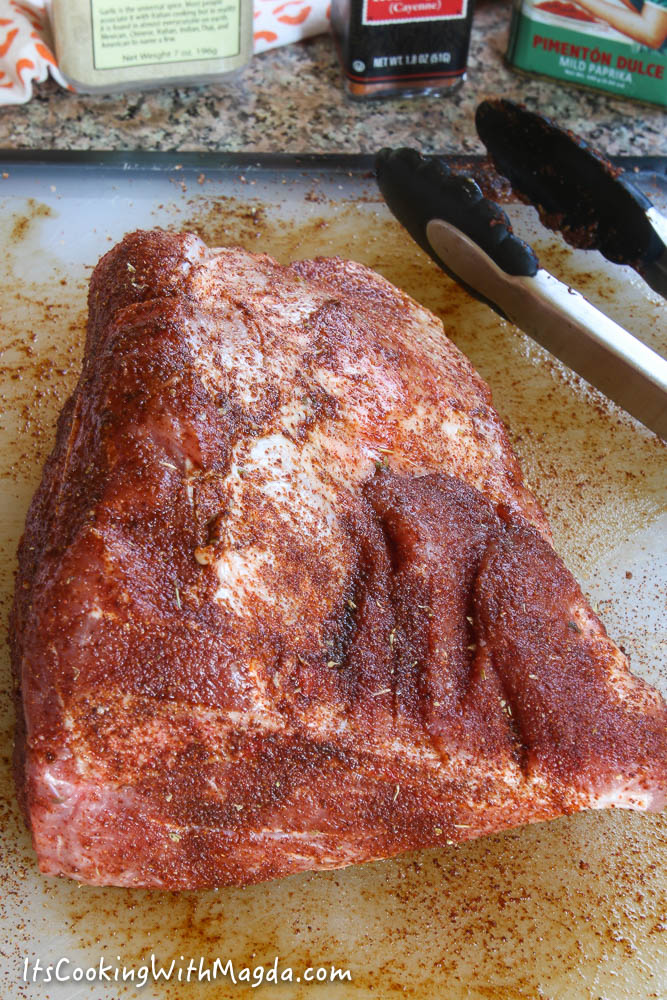 pork shoulder with spices rubbed on it